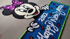 a mickey mouse birthday cake is on the floor