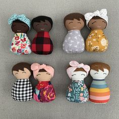 small wooden dolls are lined up on the floor