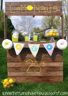 an outdoor lemonade stand is set up in the grass