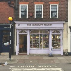 a store front with the words the highgate pantry on it's side window