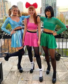 three girls in costumes posing for the camera