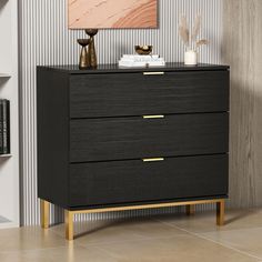 a black and gold chest of drawers in a room