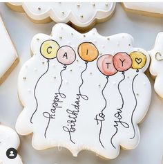 decorated cookies with balloons and the words congratulations