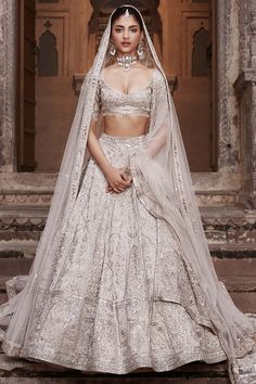 a woman in a white wedding gown and veil