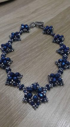 a blue and silver necklace on a table