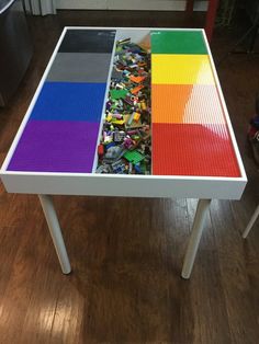 a table made out of legos on top of a wooden floor