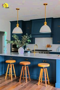 a kitchen with blue cabinets and wooden stools