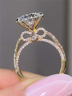 a close up view of a diamond ring on someone's finger