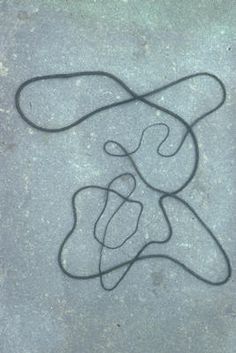 a piece of art that is on the ground with some string attached to it's side