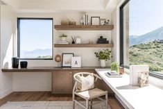 a chair sitting in front of a window next to a desk