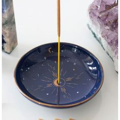 a blue plate sitting on top of a table next to crackers and a candle