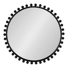 a round mirror with black beads around it