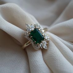 Read about our payment plans before proceeding. "Eleanor Young-Inspired Emerald and Pear Diamond Ring" Enter the world of elegance and sophistication with our Eleanor Young-Inspired Emerald and Pear Diamond Ring, paying homage to the beloved character from the top box office hit "Crazy Rich Asians." This extraordinary ring features a stunning natural emerald at its heart, encircled by six beautiful pear-shaped diamonds. The emerald ring serves as an affirmation of self-worth and love, symbolizin Green Wedding Rings, Royal Rings, Fantasy Clothes, Emerald Ring Vintage, Crazy Rich, Emerald Wedding Rings, Cute Engagement Rings, Future Engagement Rings, Emerald Wedding