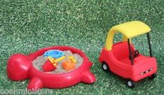 two toy cars with sand in them on the grass