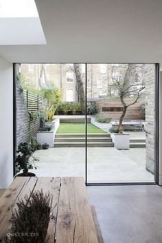 an open living room with sliding glass doors leading to the back yard and garden area