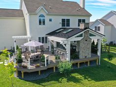 an aerial view of a house with a patio and covered deck in the middle of it