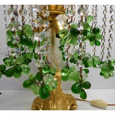 a table lamp with green glass beads on it