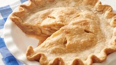 a close up of a pie on a plate with a blue and white checkered table cloth