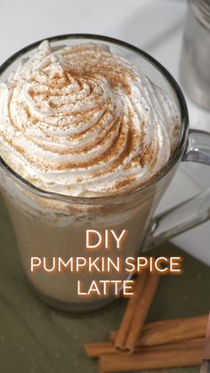 pumpkin spice latte in a glass mug with cinnamon sticks on the side and text overlay that reads diy pumpkin spice latte