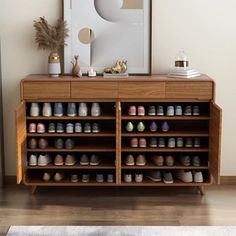 a wooden cabinet with many pairs of shoes on it