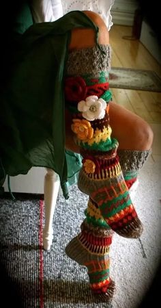 a woman is wearing colorful knitted socks with flowers on them