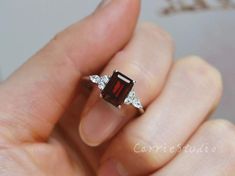 Emerald Cut Natural Garnet ring, made with 925 sterling silver, plated with white gold, beautiful promise ring, special gift for anniversary.Main Stone: Natural GarnetCut: EmeraldMeasurerment: 6*8 mm Side Stone: CZCS0328 Beautiful Promise Rings, Garnet Ring Silver, Stackable Rings Wedding, Garnet Engagement Ring, Red Garnet Ring, Mom Ring, Diamond Cluster Engagement Ring, Alexandrite Engagement Ring, Topaz Engagement Ring