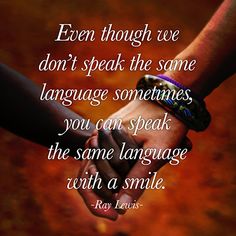 two people holding hands with the quote even though we don't speak the same language sometimes, you can speak the same language with a smile