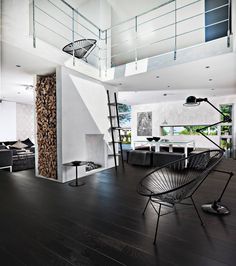 a living room filled with furniture next to a fire place under a spiral stair case