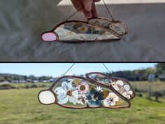 two pictures with flowers on them and one is hanging from a chain in the grass