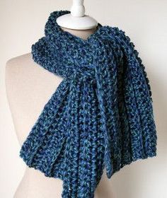 a mannequin wearing a blue knitted scarf