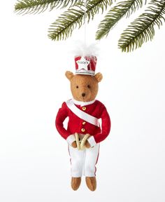 a teddy bear ornament hanging from a christmas tree