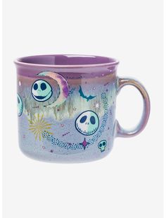 a purple coffee cup with skulls and stars on the outside, painted in blue and pink