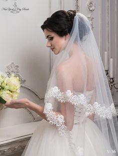 a woman in a wedding dress holding flowers