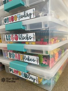 plastic bins filled with lego blocks and name tags on the bottom, along with clear storage containers