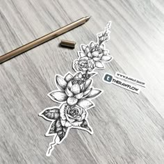 a sticker with flowers on it next to a pencil and paper clippings