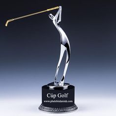 a silver trophy with a woman holding a golf club on it's back and the words cup golf