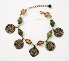 Carry a piece of Ireland wherever you go when you wear this charm bracelet. Celtic castles cover four of the charms dangling from the design of Connemara marble beads and glass lamp beads.