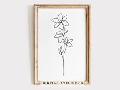 a black and white drawing of a flower in a wooden frame with the words digital atelier