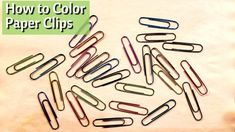 several paper clips sitting on top of a piece of paper with the words how to color paper clips