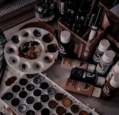 an artist's palette with lots of paint and other items on the table next to it