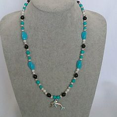 New With Tags This Custom Handmake Necklace Is 22 Inch Turquoise, Black, And Silver Beaded Necklace With A Turquoise Rhinestone Dolphin Charm And A Toggle Clasp. Made With Acrylic Beads To Keep It Lightweight. This Necklace Has A Matching Bracelet And Earrings. Purple Stone Necklace, Dolphin Charm, Rock Crystal Necklace, Silver Beaded Necklace, Three Necklaces, Blue Statement Necklace, Shark Tooth Necklace, Sunflower Necklace, Round Pendant Necklace