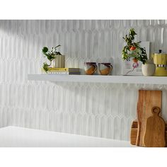 a shelf with cutting boards and vases on it