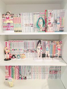 two white shelves filled with anime books and figurines on top of each shelf