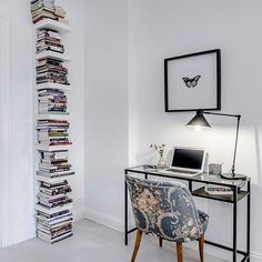 a chair sitting in front of a desk with a laptop computer on top of it