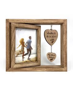 a wooden frame with two hearts hanging from it and a key chain attached to it