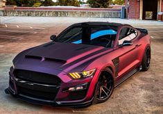 a purple mustang parked in a parking lot