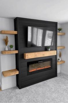 a tv mounted on top of a wooden shelf next to a fire place in a living room