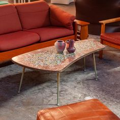 a living room with two couches and a coffee table in the middle of it