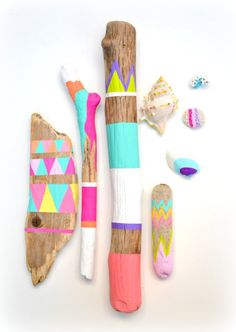 some colorful items are laying out on a white surface with shells and seashells