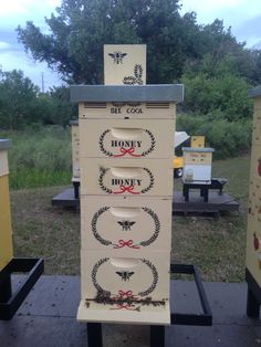 a beehive with the words honey on it in front of some other bees